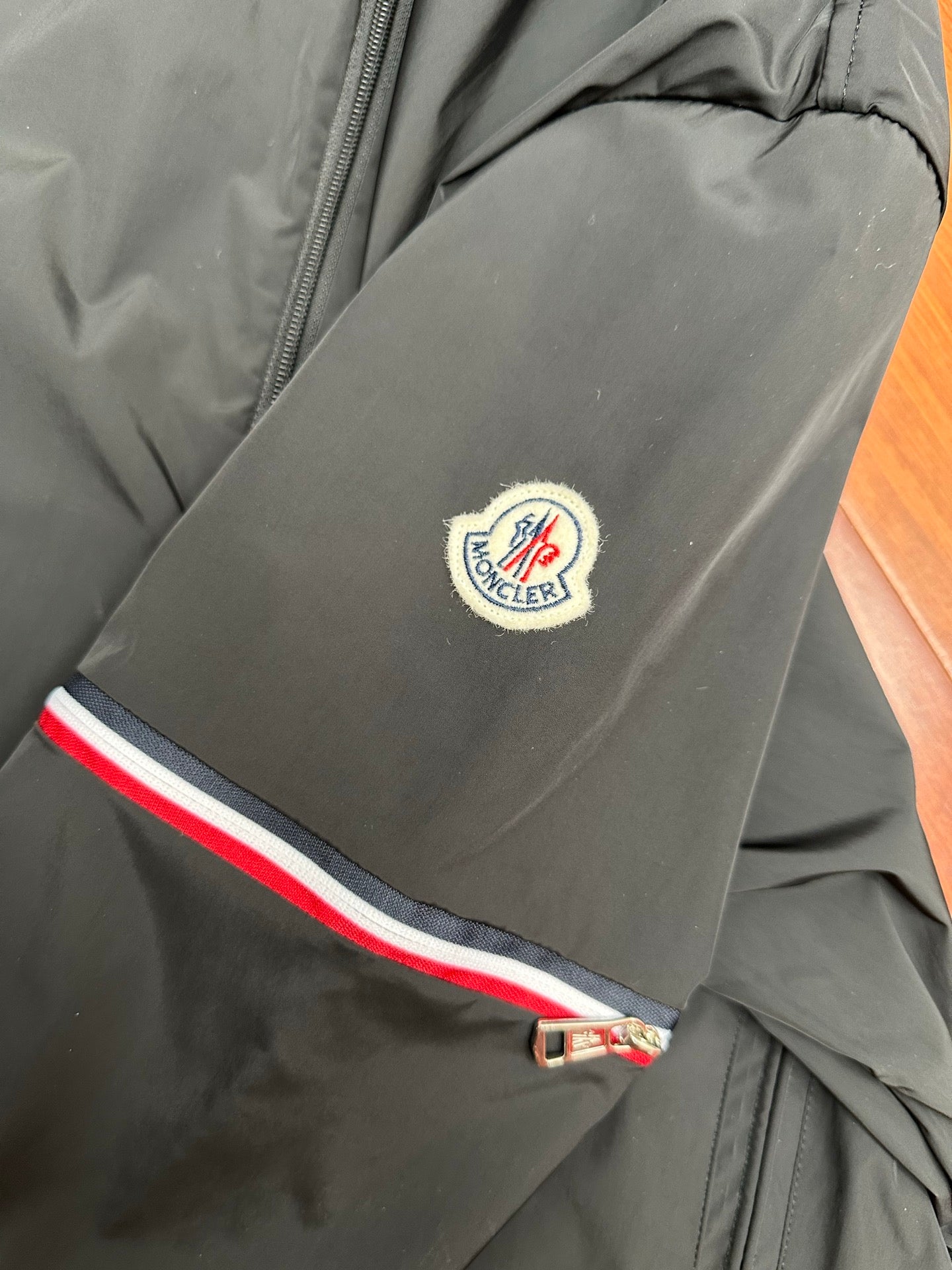 Moncler long jacket with chest logo patch and tri-color stripe at hem