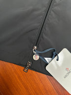 Moncler long jacket zipper with branded pull tab and blue drawstring tag