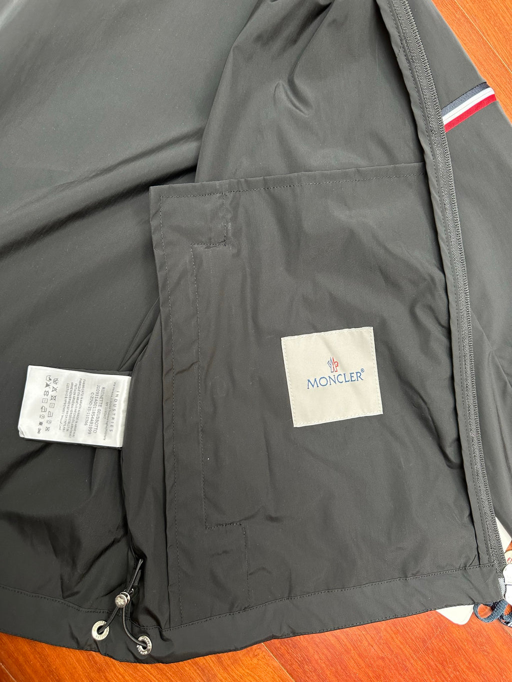 Moncler long jacket interior with care labels and small logo patch
