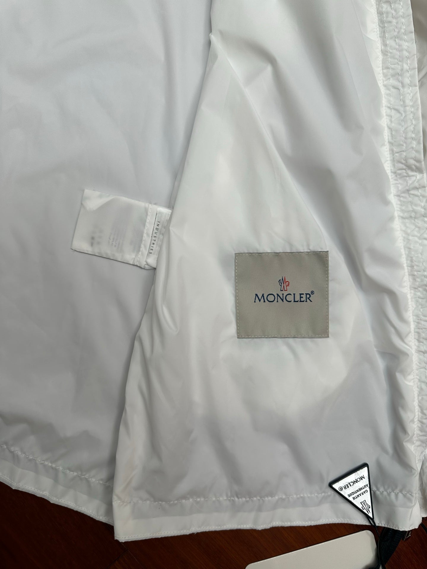 Moncler long white jacket with square Moncler logo patch