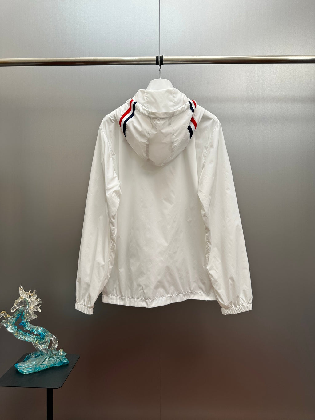Moncler long white hooded jacket, rear view with red-and-blue sleeve stripe