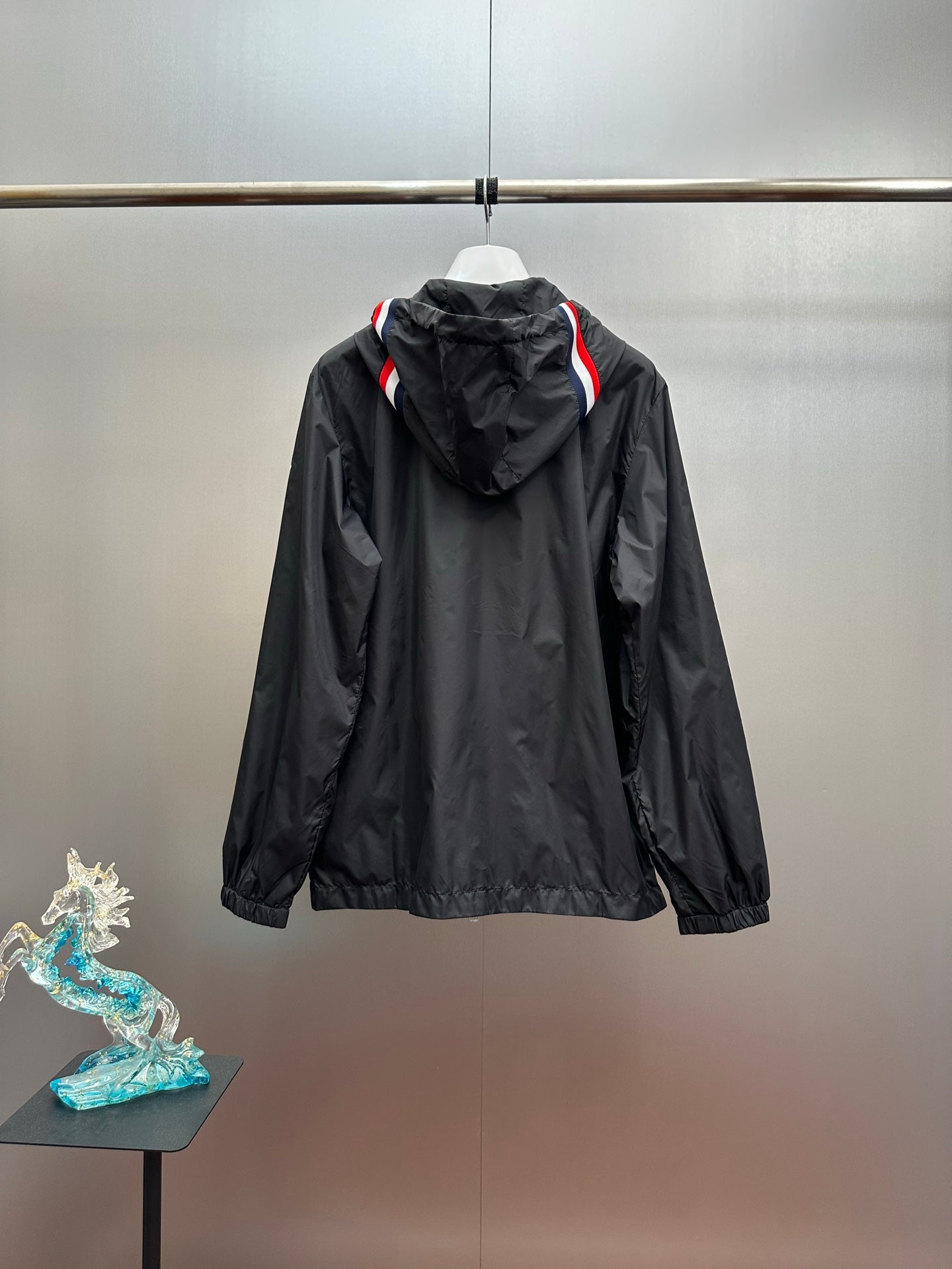 Moncler long hooded jacket, back view, black with red/blue stripe hood trim