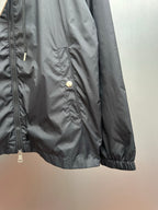 Moncler long black jacket side detail with front zipper and snap pocket