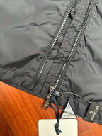 Moncler long black jacket close-up of silver zipper and hood drawcord