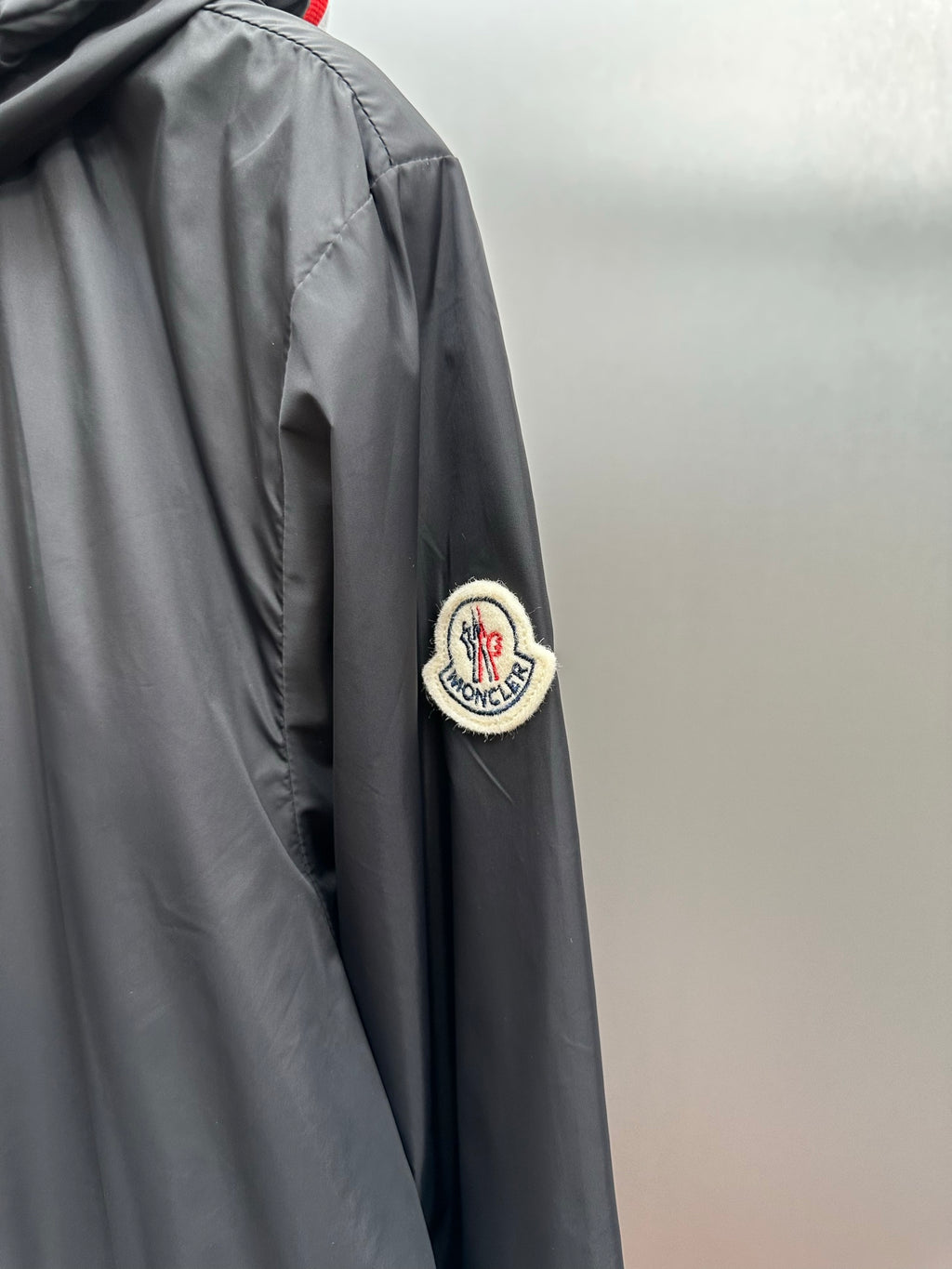 Moncler long black jacket with round patch logo on sleeve