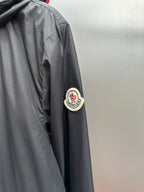 Moncler long black jacket with round patch logo on sleeve