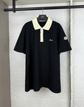 Moncler polo shirt with black body, cream collar, and button placket