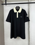 Moncler polo shirt with black body, cream collar, and button placket