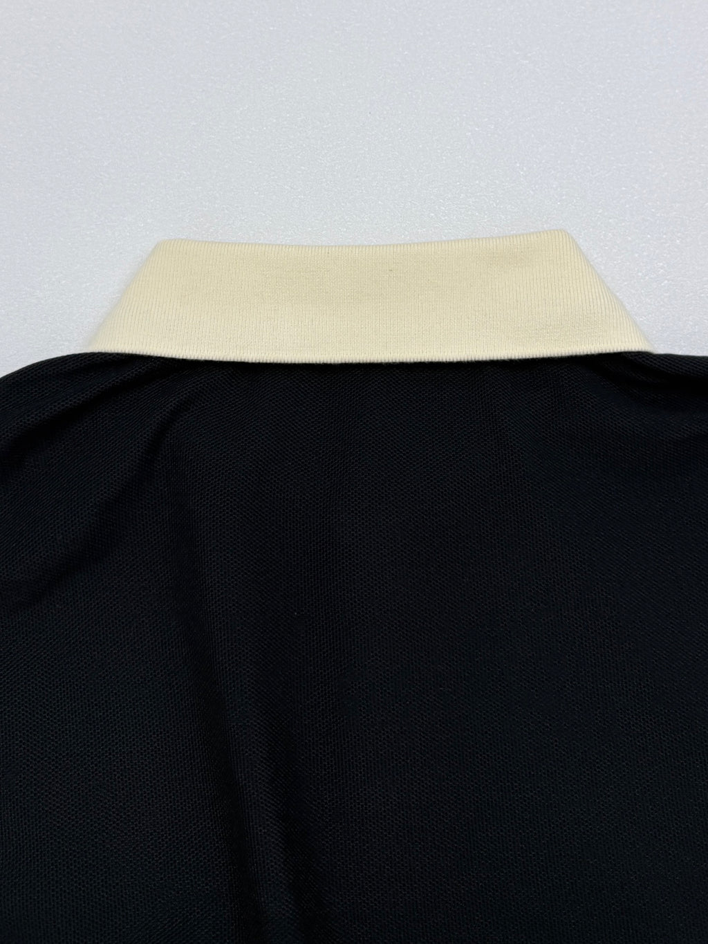 Moncler polo shirt collar edge, cream top with black body
