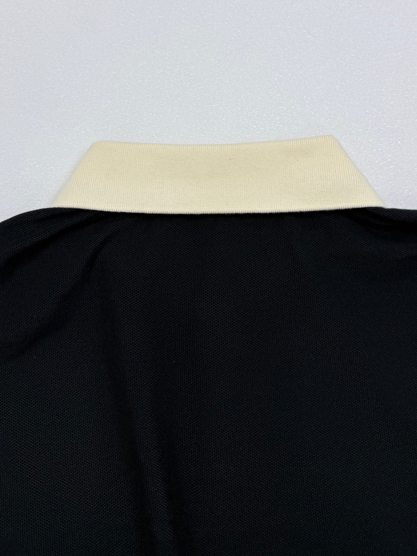 Moncler polo shirt collar edge, cream top with black body