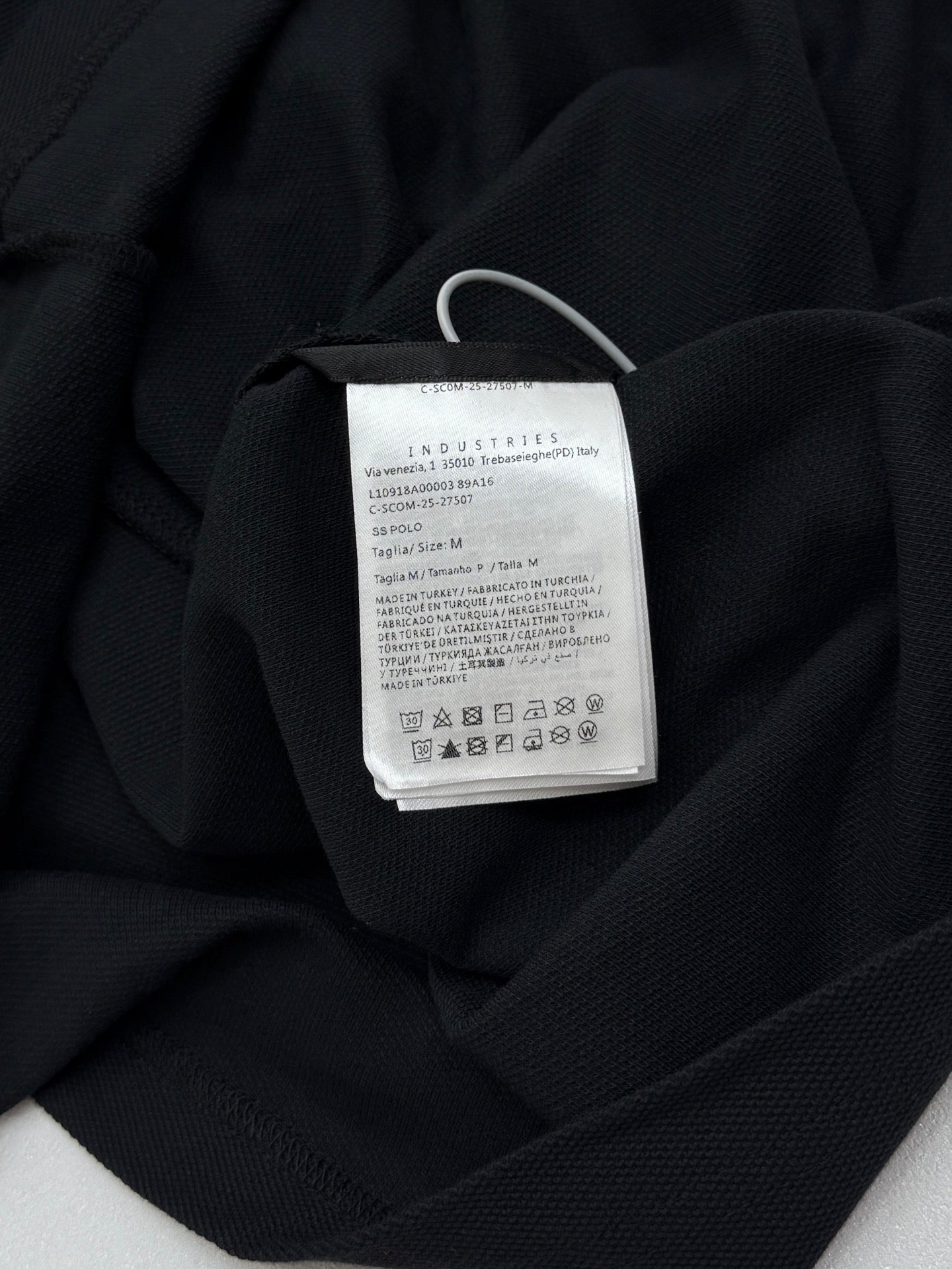 Moncler polo shirt interior neck label with care and size text