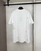 White short-sleeve T-shirt with scattered daisy embroidery on the back