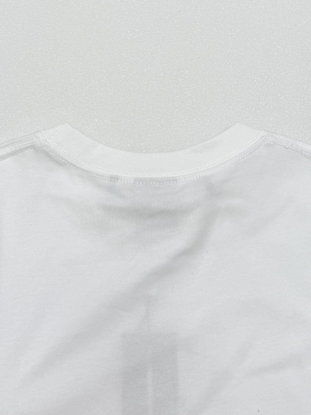 White crew-neck T-shirt collar seam and stitched edge