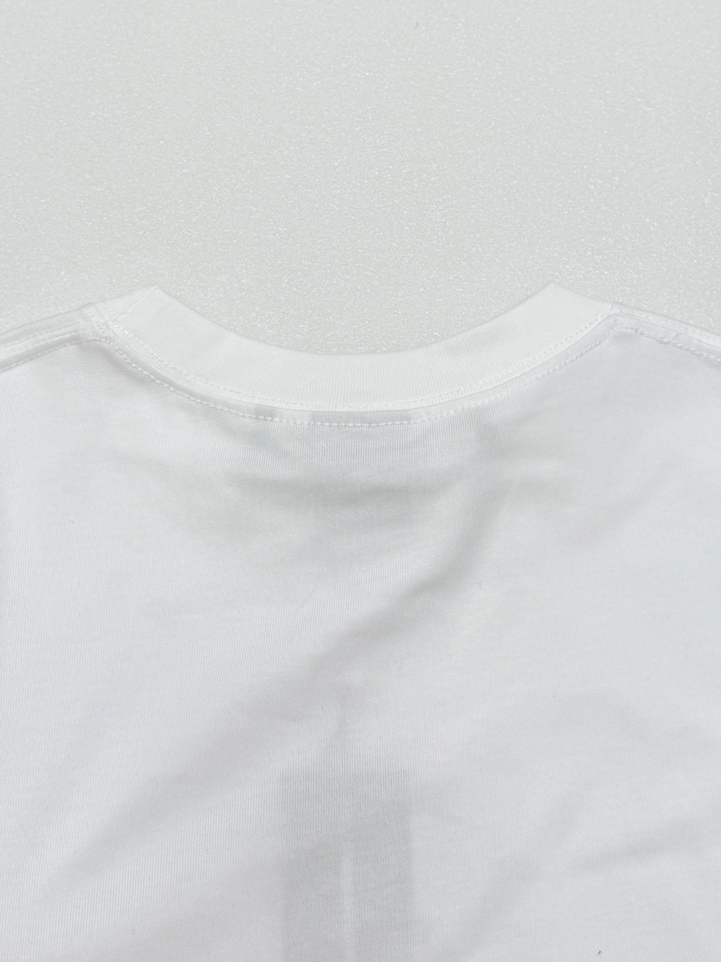 White crew-neck T-shirt collar seam and stitched edge
