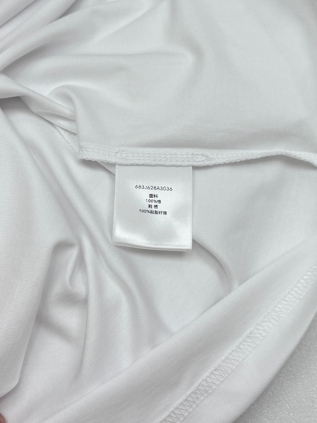 White T-shirt interior neck label with printed size details
