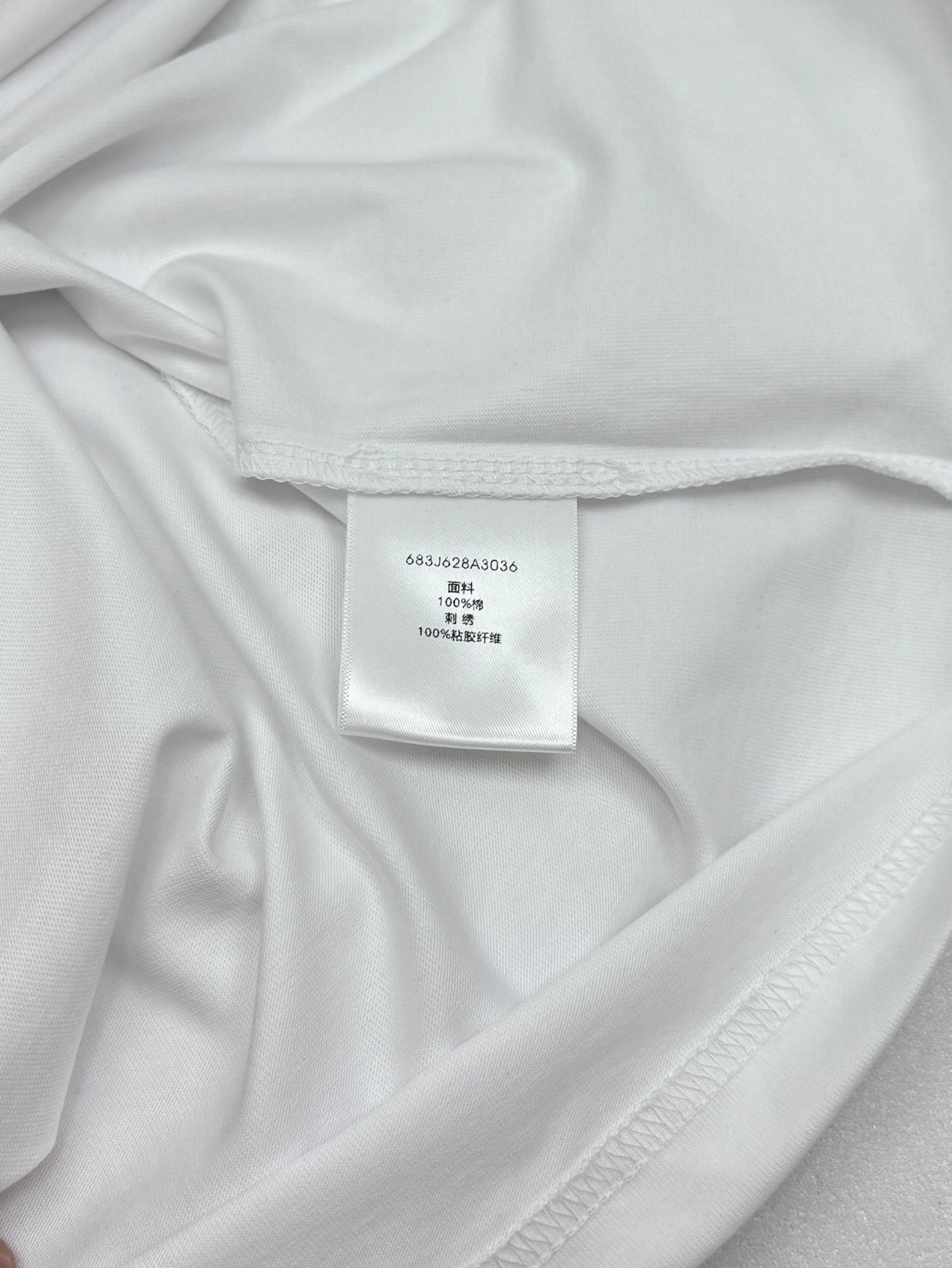 White T-shirt interior neck label with printed size details