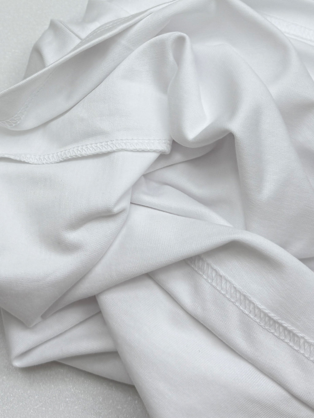 White T-shirt fabric with stitched side seam detail