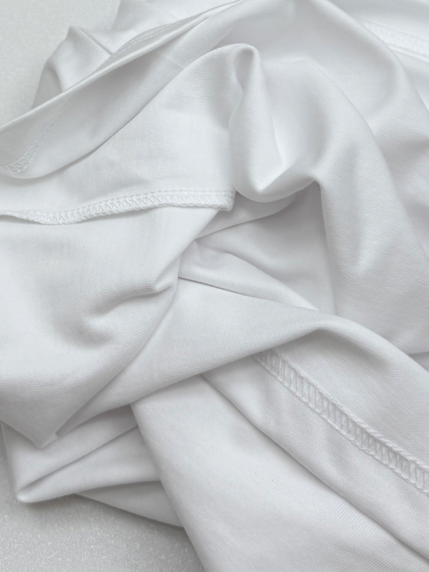 White T-shirt fabric with stitched side seam detail