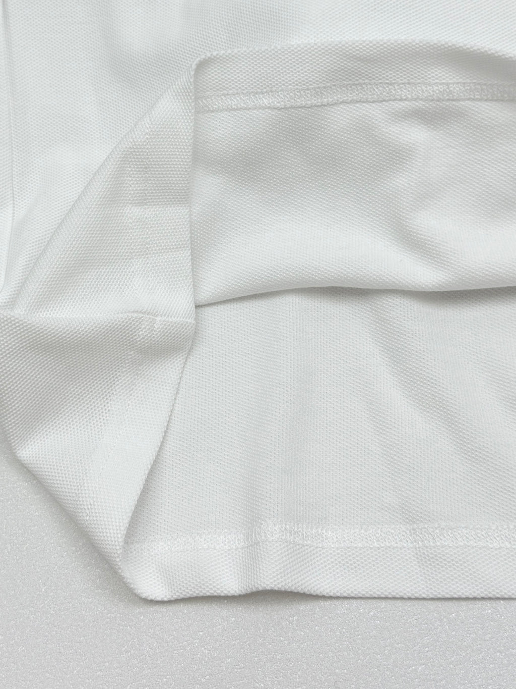 Moncler white polo shirt cuff and folded hem detail