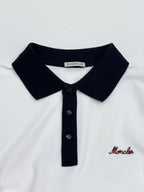 Moncler polo collar with black knit edge and three dark buttons, white shirt