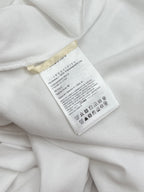 Moncler size and care label on white polo shirt interior