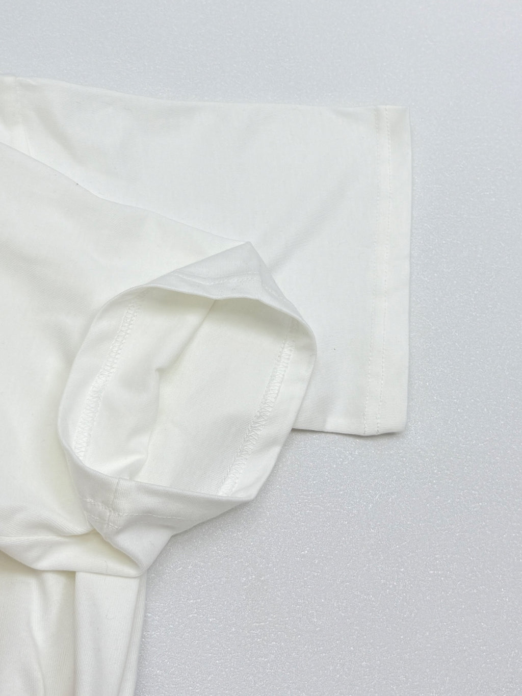 White Louis Vuitton T-shirt sleeve and hem close-up