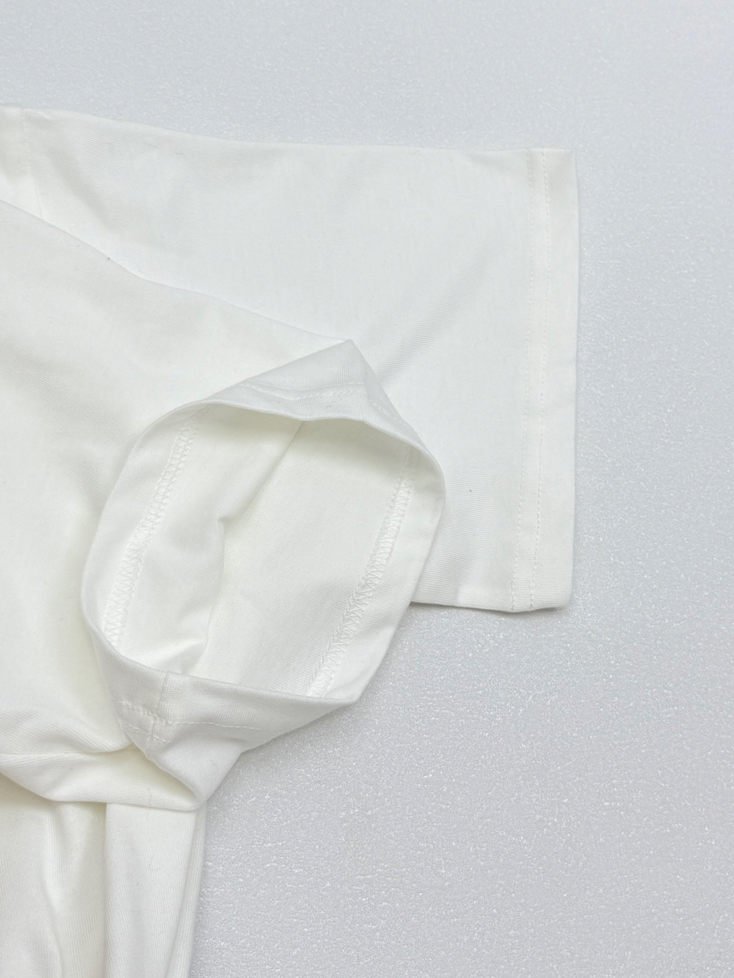White Louis Vuitton T-shirt sleeve and hem close-up