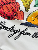 White Louis Vuitton T-shirt close-up of multicolor shell graphic and script