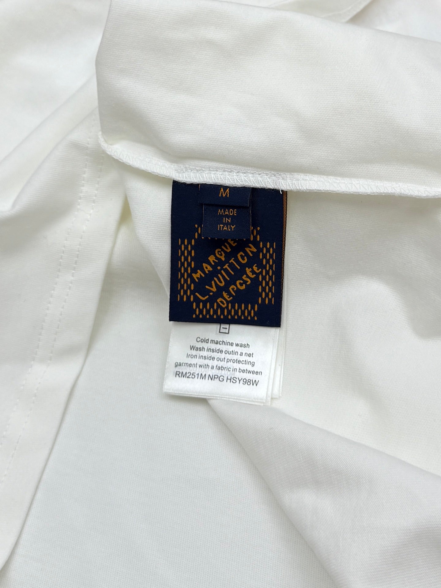 White Louis Vuitton T-shirt fabric tag showing size M and Made in Italy