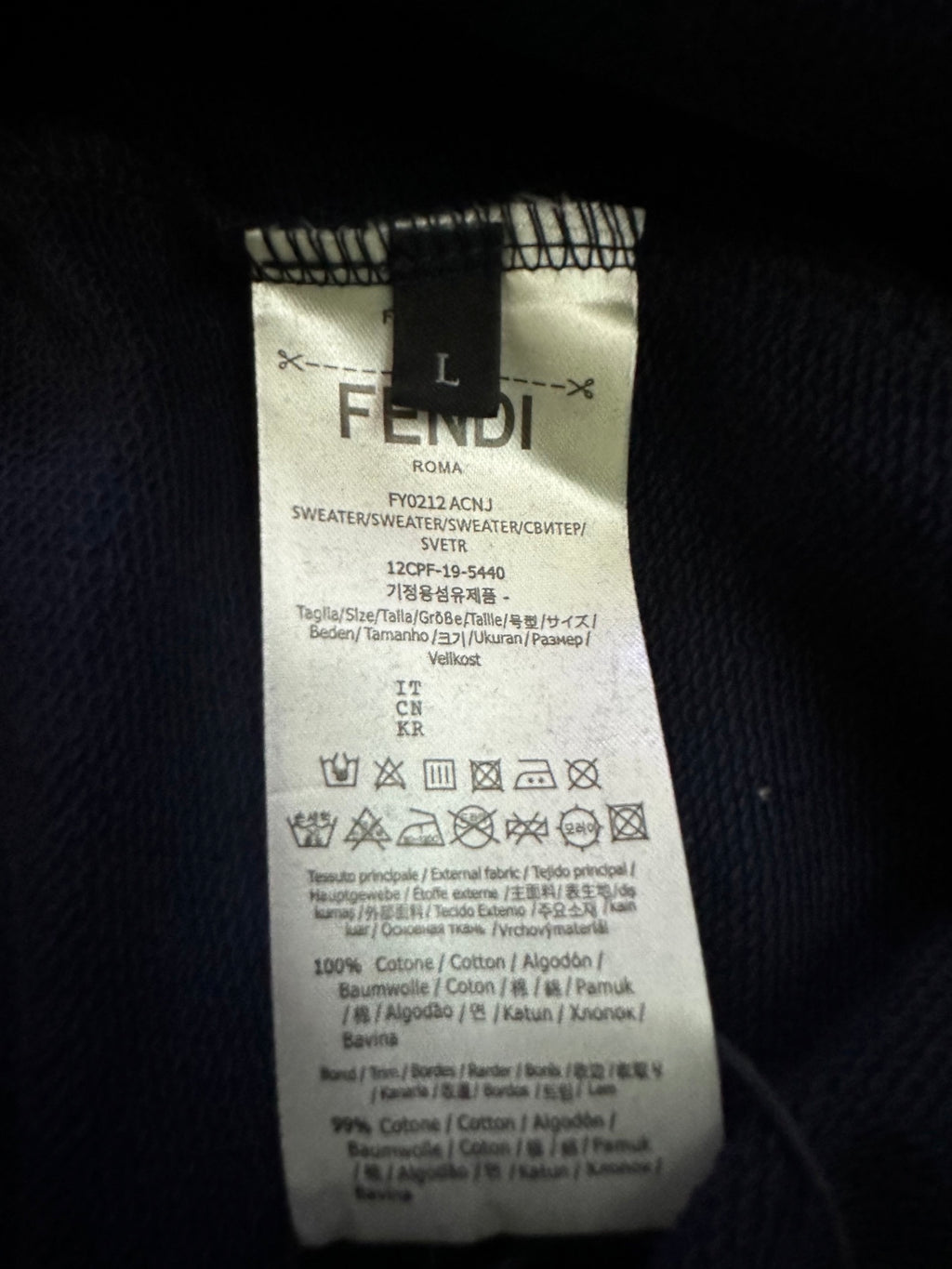 Inside label on navy Fendi hoodie, size L and care information tag