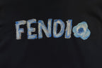 Close-up of blue FENDI logo on dark hoodie fabric