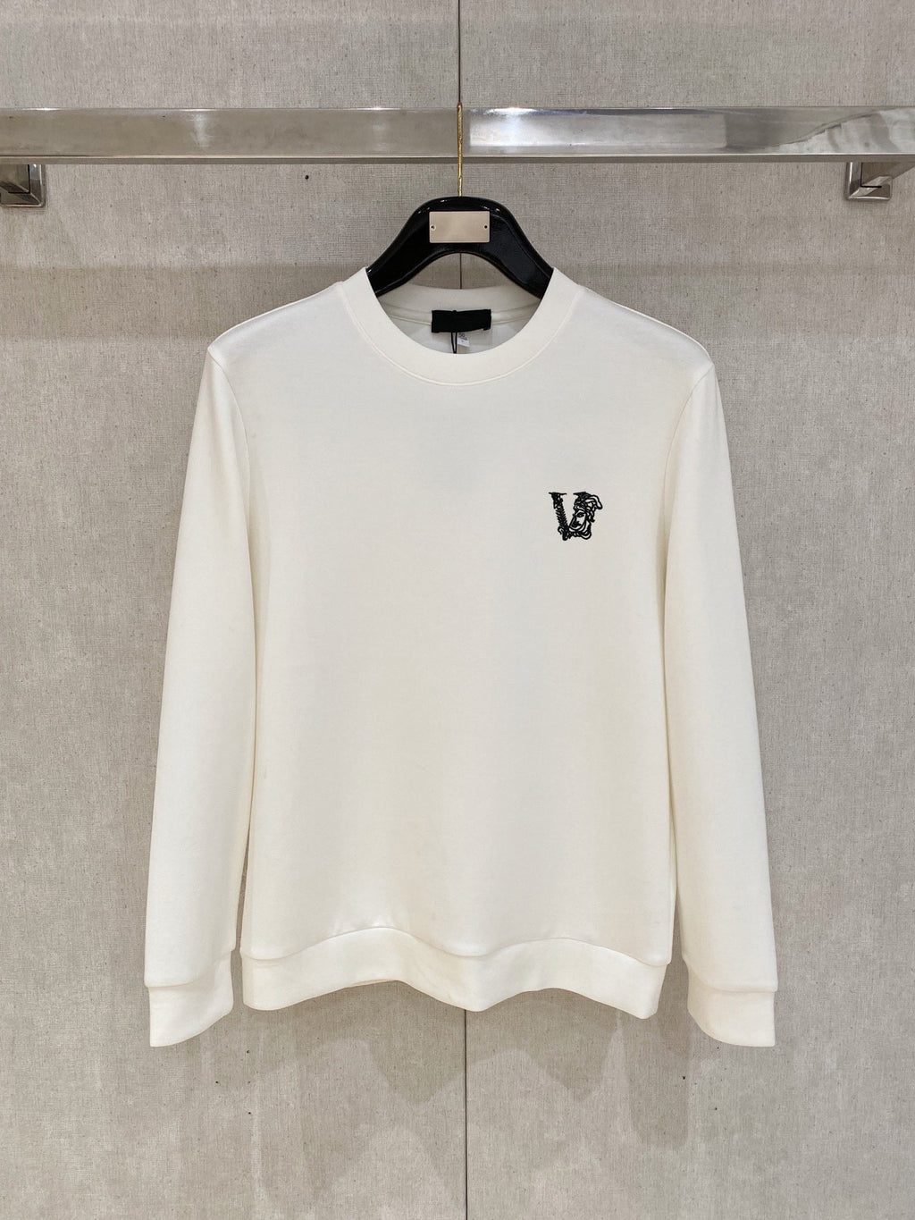 White crewneck sweatshirt with small V logo on left chest