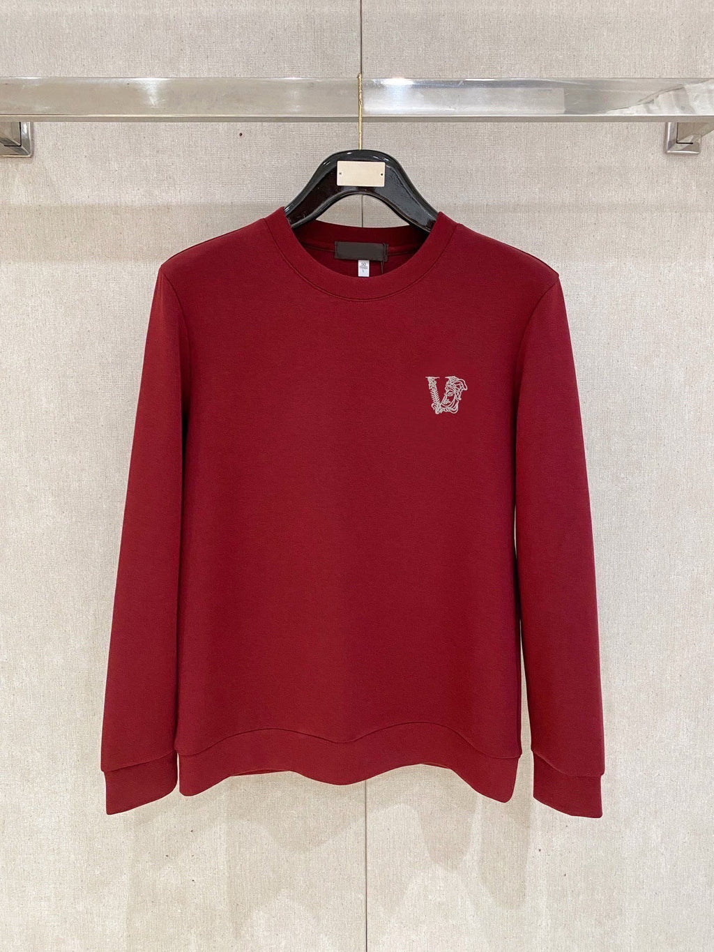 Burgundy crewneck sweatshirt with small V logo on left chest