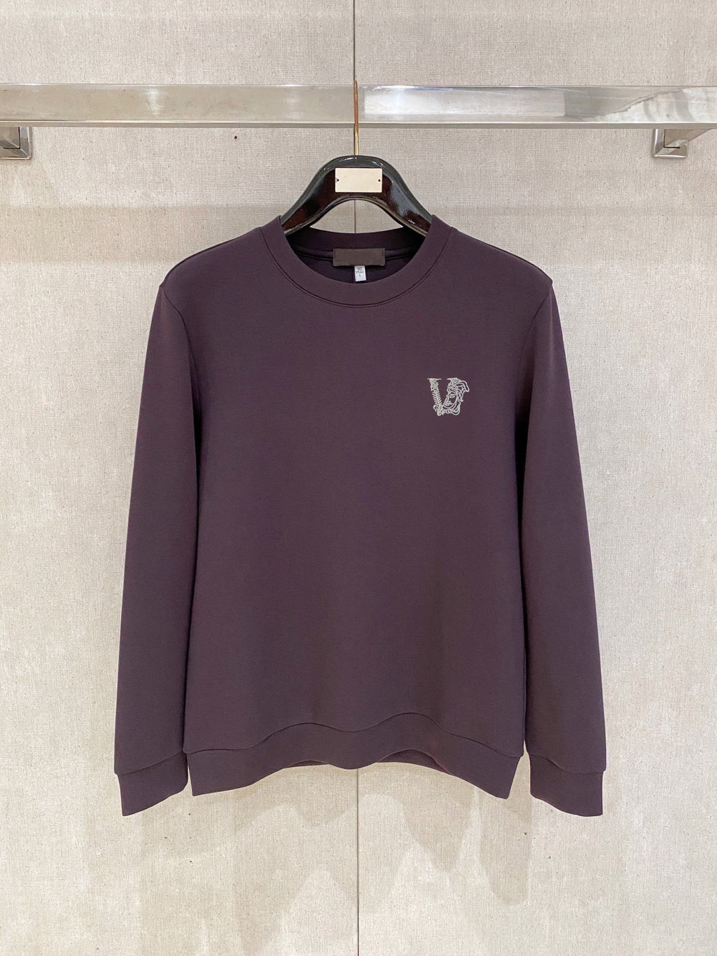 Purple crewneck sweatshirt with small V logo on left chest