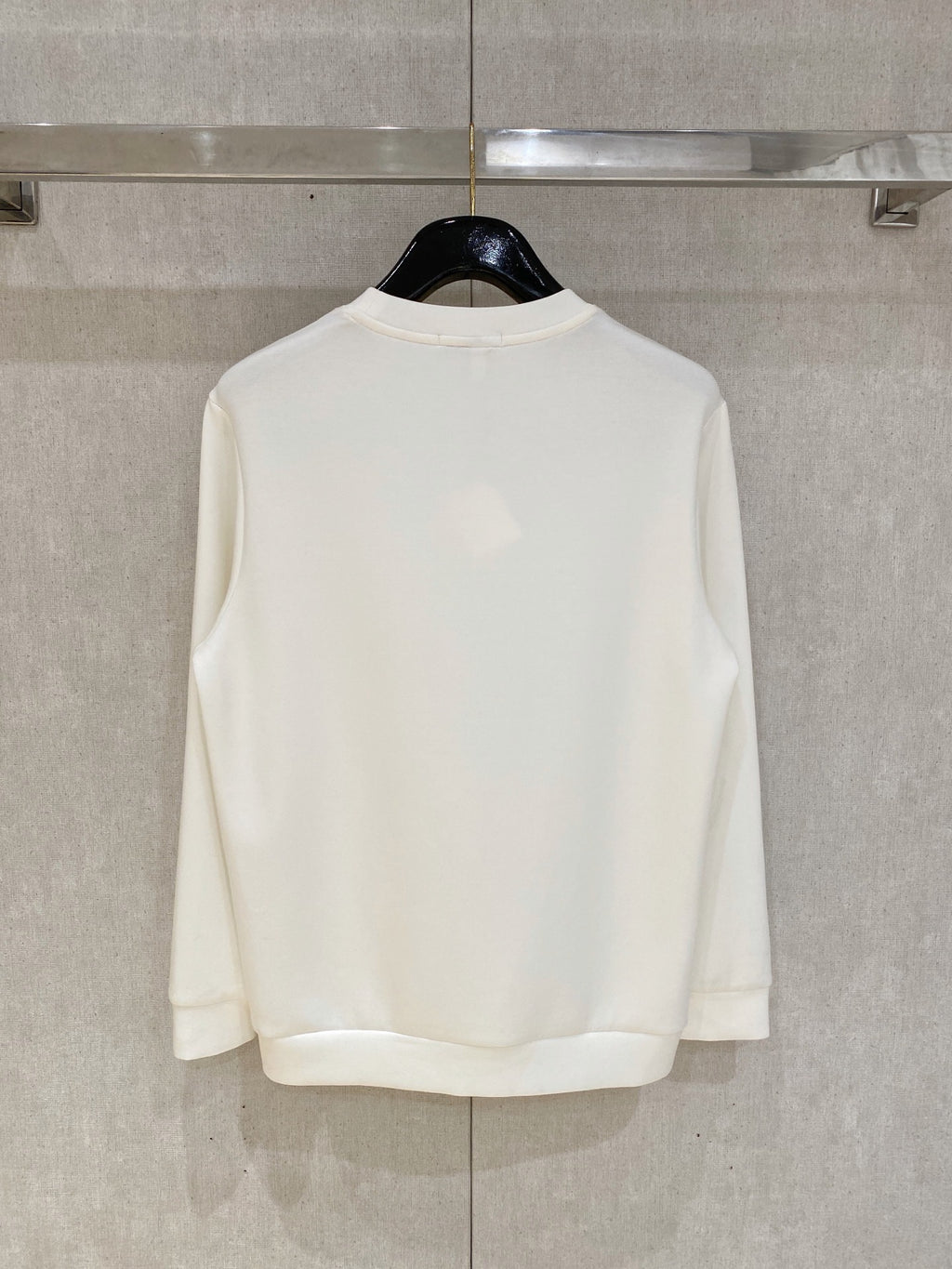 White crewneck sweatshirt back view with crew neckline and hem