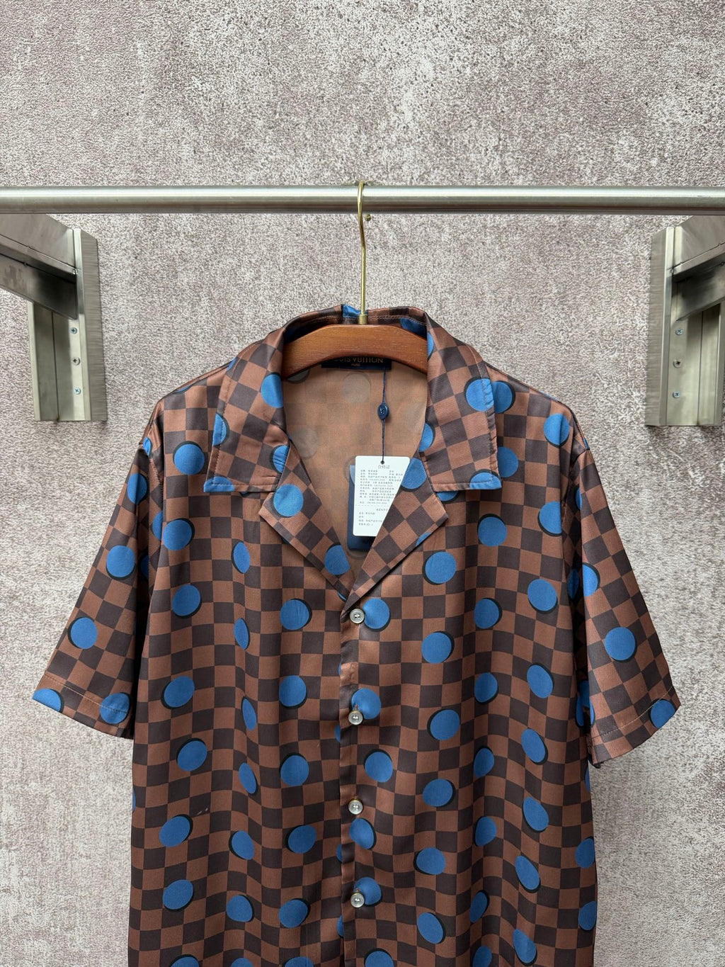 Brown short-sleeve button-up shirt with blue dot checker print and pointed collar