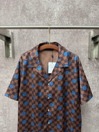 Brown short-sleeve button-up shirt with blue dot checker print and pointed collar