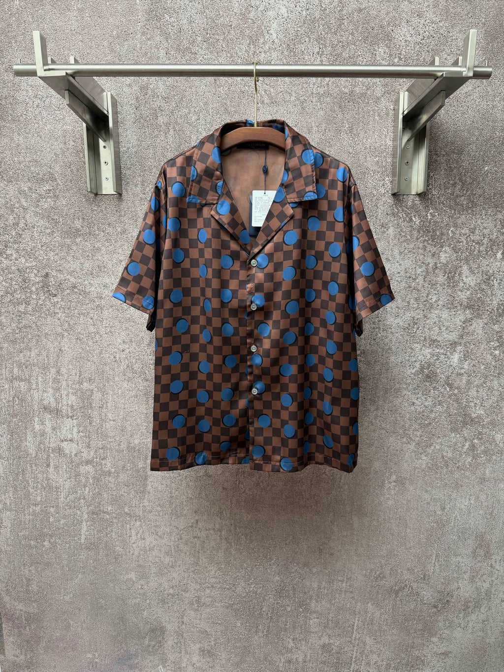 Brown short-sleeve shirt with blue checker pattern and large circular motifs