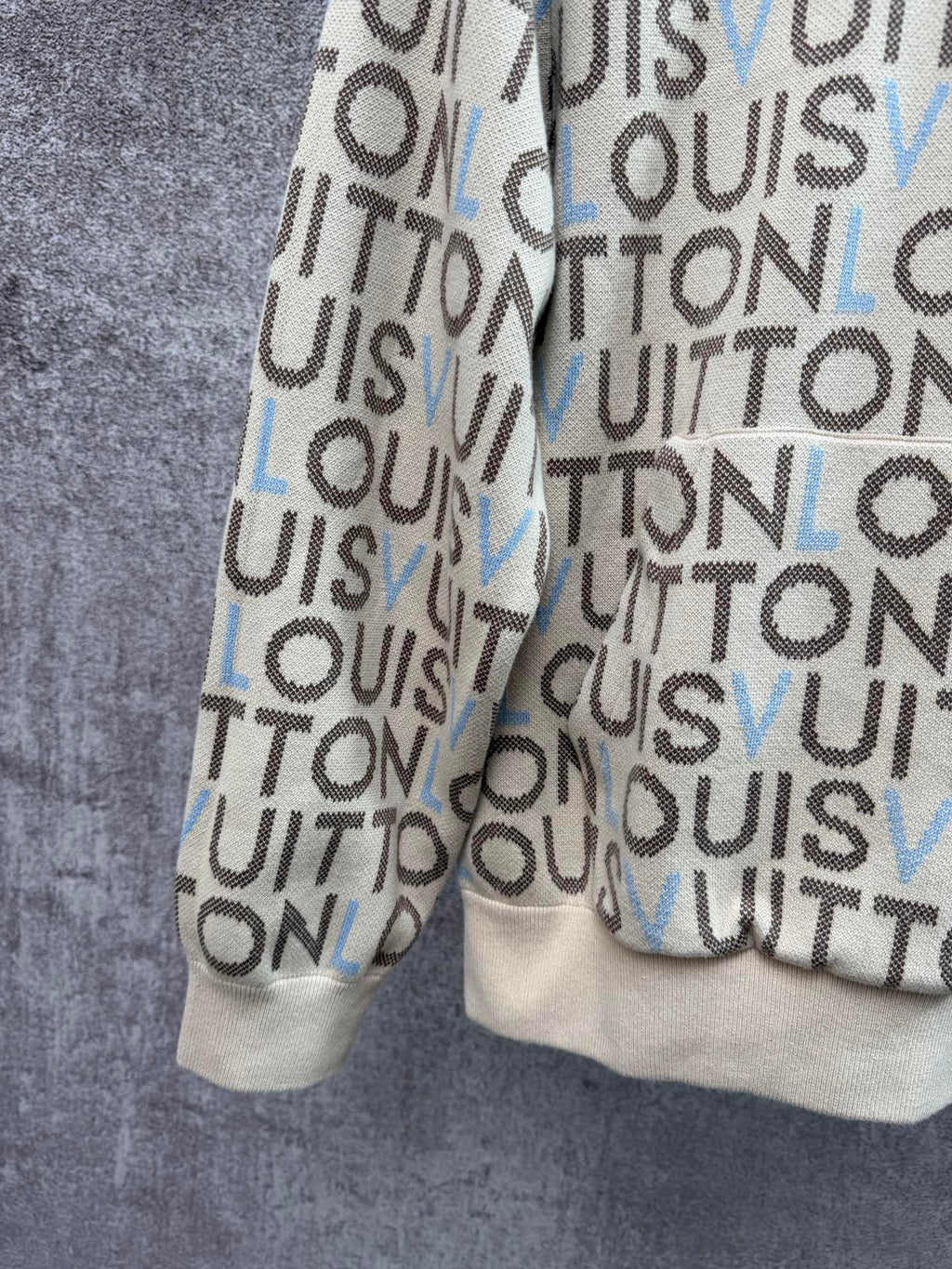 Louis Vuitton monogram zip-up hoodie side view, cream knit with blue letter accents