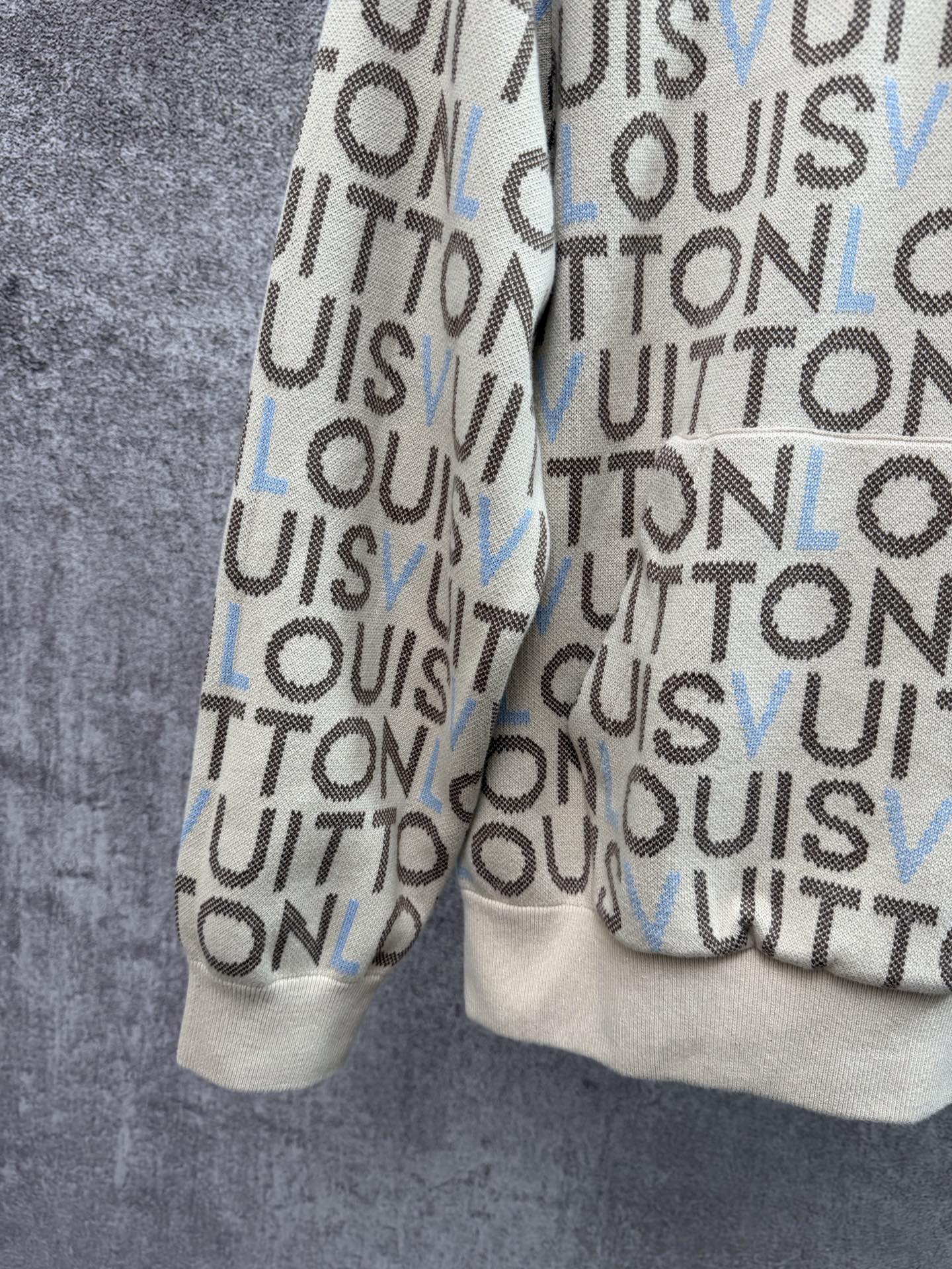 Louis Vuitton monogram zip-up hoodie side view, cream knit with blue letter accents