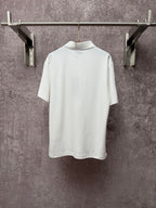 White Dior polo shirt back view with collar and short sleeves