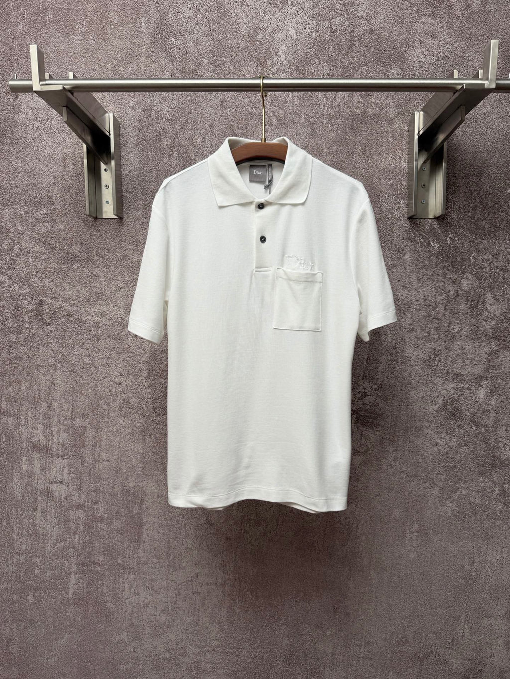 White Dior polo shirt with short sleeves, button placket, and chest pocket