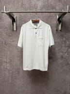 White Dior polo shirt with short sleeves, button placket, and chest pocket