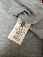 Care label on light gray Dior short-sleeve polo knit