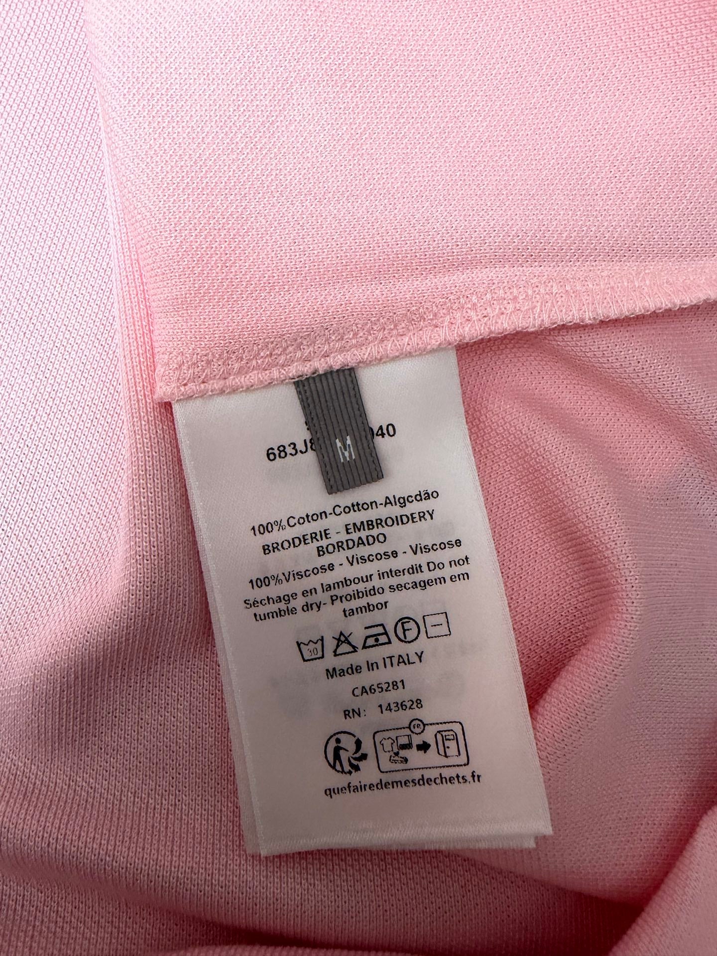 Dior polo shirt care label and size tag inside light pink fabric
