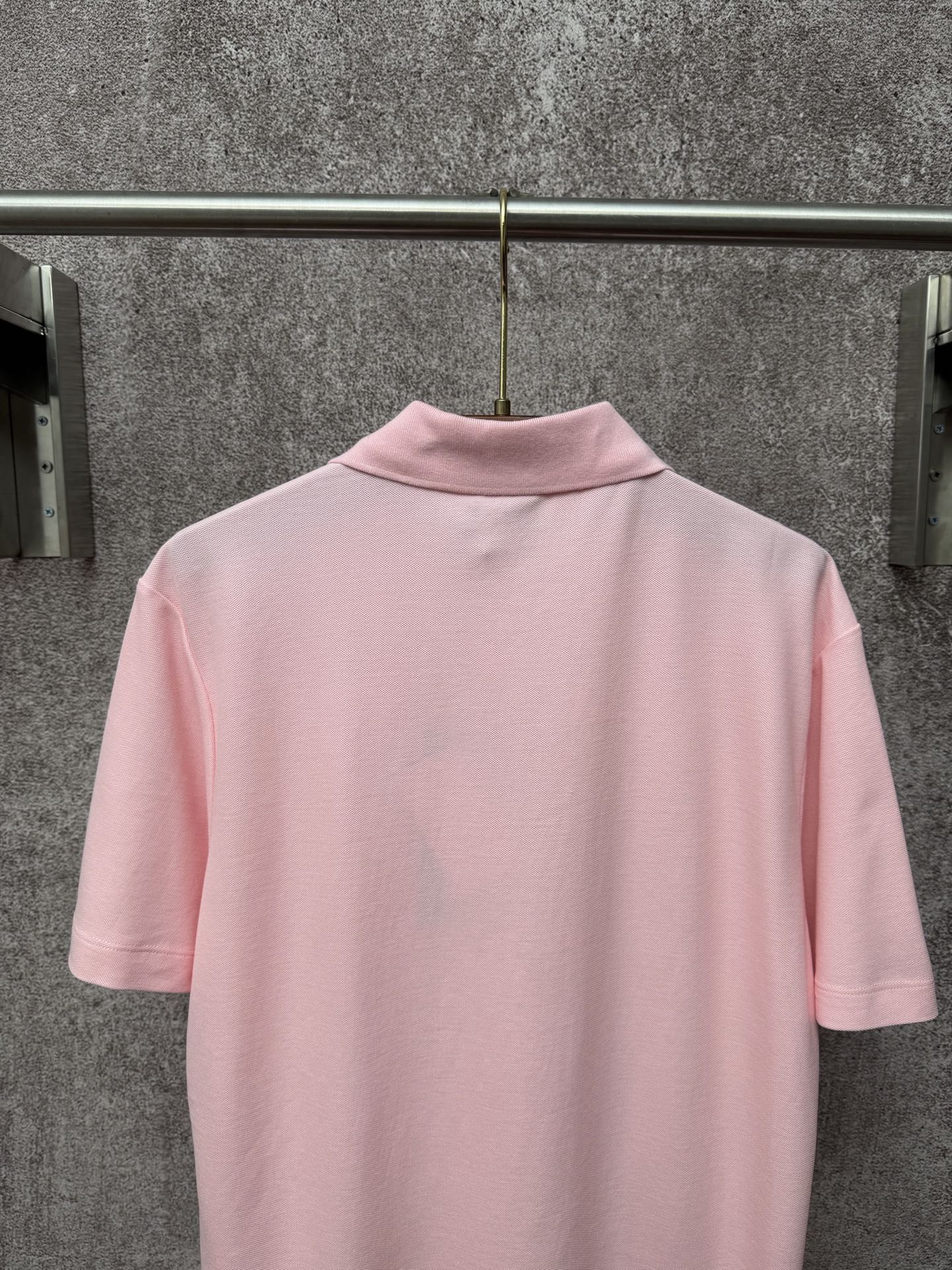 Dior polo shirt in light pink, back view with ribbed collar and short sleeves
