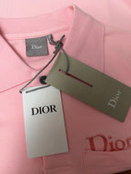 Dior polo shirt collar in light pink with attached brand tag and hang tag