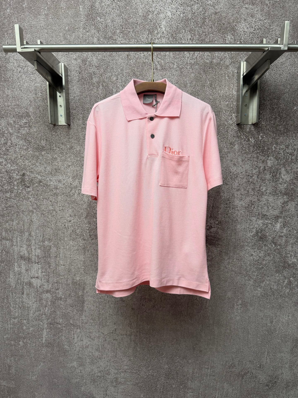 Dior short-sleeve polo shirt in light pink, with collar, buttons, and chest pocket