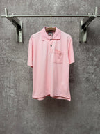 Dior short-sleeve polo shirt in light pink, with collar, buttons, and chest pocket