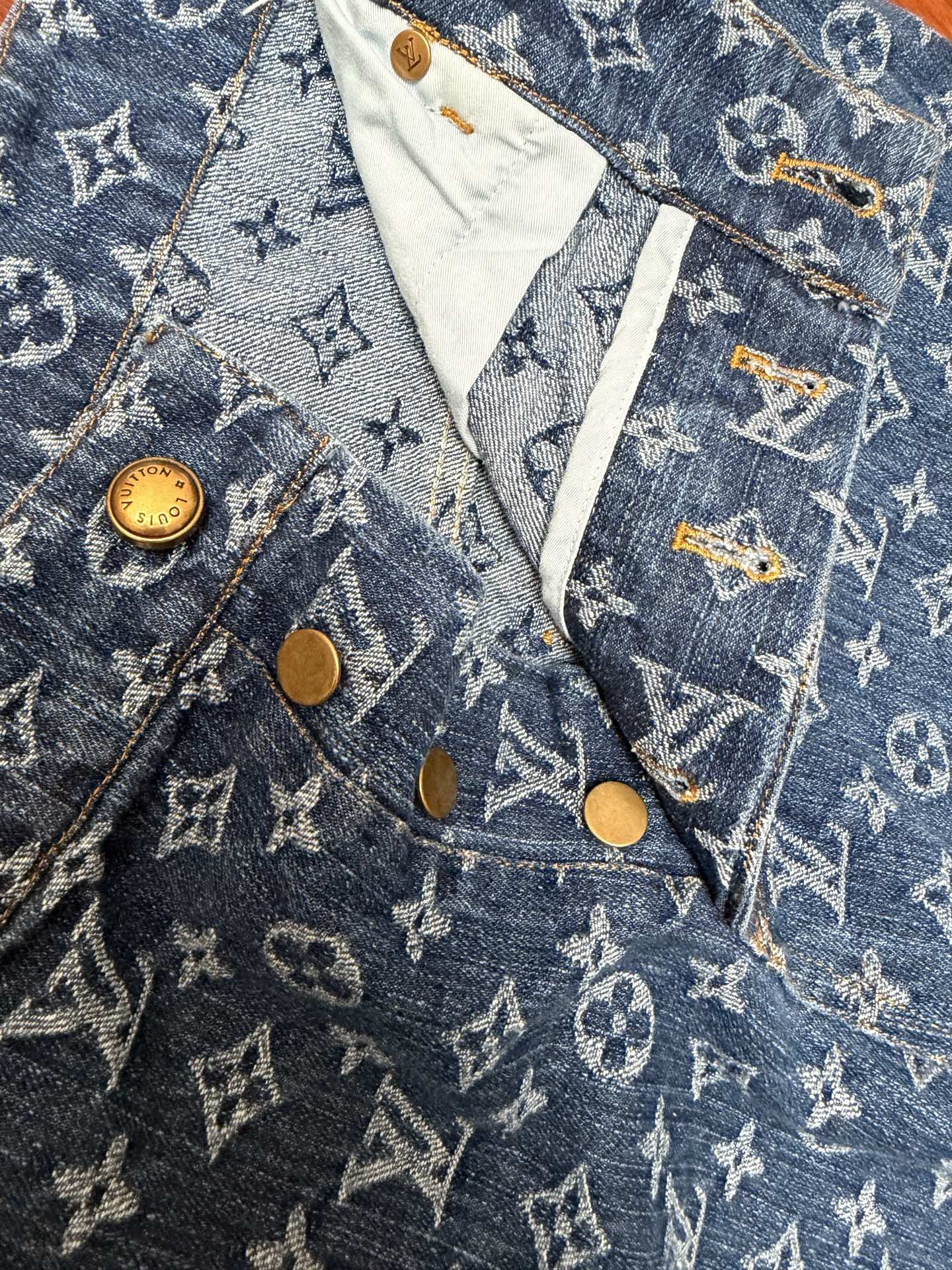 Louis Vuitton monogram denim shorts front with flap pocket and gold buttons